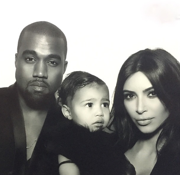 Kanye West poses with his daughter North West and wife, Kim Kardashian