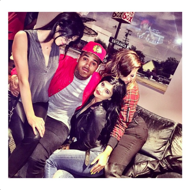Kendall took a seat on Chris' lap.
